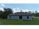 This home features a sliding glass door, a neutral paint scheme, and a spacious yard at 4127 Snowdrop St, North Port, FL 34288