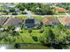 Aerial view showcases the property's backyard with pond access, screened-in pool, and proximity to neighborhood at 420 Wabash Ter, Port Charlotte, FL 33954