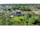 Aerial view showcasing the property's backyard, screened-in pool, solar panels, and surrounding neighborhood at 420 Wabash Ter, Port Charlotte, FL 33954