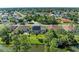 Aerial view of the home showcasing its screened-in pool and backyard in a quiet, tree-lined neighborhood at 420 Wabash Ter, Port Charlotte, FL 33954