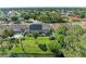 An aerial perspective captures the pool, solar panels, and backyard leading to a picturesque water view at 420 Wabash Ter, Port Charlotte, FL 33954