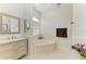 Relax in this bathroom with a jacuzzi tub, vanity sink, and a window for natural light at 420 Wabash Ter, Port Charlotte, FL 33954
