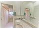 Well-lit bathroom featuring dual sinks, granite countertops, and a large mirror at 420 Wabash Ter, Port Charlotte, FL 33954