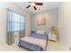 Serene bedroom with a large window providing natural light, complimented by art and fresh flowers at 420 Wabash Ter, Port Charlotte, FL 33954