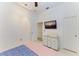 Minimalist bedroom with a flat-screen television and two points of entry to other rooms at 420 Wabash Ter, Port Charlotte, FL 33954