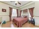 Cozy bedroom featuring a comfortable bed, ceiling fan, and warm, inviting decor at 420 Wabash Ter, Port Charlotte, FL 33954
