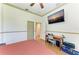 Bright bedroom featuring neutral colors, ceiling fan, desk and large, wall mounted television at 420 Wabash Ter, Port Charlotte, FL 33954