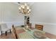 Formal dining room featuring wood floors, wainscoting, and a stylish chandelier at 420 Wabash Ter, Port Charlotte, FL 33954