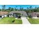 Single-Gathering home featuring a well-manicured lawn, mature landscaping, and ample driveway parking at 420 Wabash Ter, Port Charlotte, FL 33954