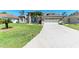 Charming single-story home boasting a manicured lawn, beautiful landscaping, and an attached two-car garage at 420 Wabash Ter, Port Charlotte, FL 33954