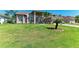Expansive front yard featuring a well-manicured lawn and meticulously maintained landscaping at 420 Wabash Ter, Port Charlotte, FL 33954
