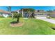 Beautiful single-story home with manicured front lawn, palm trees, and an attached two-car garage at 420 Wabash Ter, Port Charlotte, FL 33954