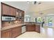 Gourmet kitchen with granite countertops, stainless steel appliances, and dark wood cabinetry at 420 Wabash Ter, Port Charlotte, FL 33954