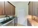 Practical laundry room featuring modern washer and dryer, along with ample counter space and storage at 420 Wabash Ter, Port Charlotte, FL 33954