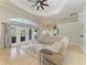 Open living room featuring tile flooring, a ceiling fan, and doors to the backyard at 420 Wabash Ter, Port Charlotte, FL 33954