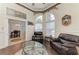 Cozy living room with a leather sofa, glass coffee table, and an adjacent dining area at 420 Wabash Ter, Port Charlotte, FL 33954