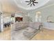 Open-concept living room with tile flooring, a modern ceiling fan, and a large sectional sofa on a plush rug at 420 Wabash Ter, Port Charlotte, FL 33954