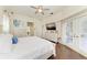 Relax in the spacious main bedroom featuring an ensuite bathroom and a door leading to a private balcony at 420 Wabash Ter, Port Charlotte, FL 33954