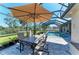 Outdoor dining area features a table with seating and pool views, perfect for enjoying meals at 420 Wabash Ter, Port Charlotte, FL 33954