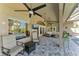 Inviting outdoor patio with brick pavers, ceiling fans, large windows, and comfortable seating area at 420 Wabash Ter, Port Charlotte, FL 33954