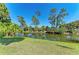 Lush greenery frames a serene pond view, showcasing the natural beauty and tranquility of the property at 420 Wabash Ter, Port Charlotte, FL 33954