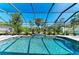 Enjoy this screened pool with a beautiful waterfall feature surrounded by tropical landscaping at 420 Wabash Ter, Port Charlotte, FL 33954