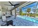 A beautiful outdoor screened-in pool area with waterfall feature, elegant patio, and comfortable seating at 420 Wabash Ter, Port Charlotte, FL 33954