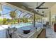 Inviting pool area with a screened enclosure, surrounded by lush greenery and comfortable seating at 420 Wabash Ter, Port Charlotte, FL 33954