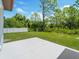 An expansive backyard with lush grass, a concrete patio, and a white picket fence at 4343 Killdeer Ter, North Port, FL 34288