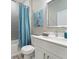 Bathroom featuring a shower with gray tiling, modern vanity, and pelican artwork at 4343 Killdeer Ter, North Port, FL 34288