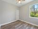 Minimalist bedroom with wood-look flooring, a ceiling fan, and lots of natural light at 4343 Killdeer Ter, North Port, FL 34288