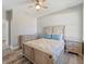 Bedroom with a ceiling fan, neutral walls and wood-look flooring at 4343 Killdeer Ter, North Port, FL 34288