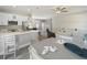 Open-concept kitchen featuring stainless steel appliances, white cabinetry, and an eat-in island at 4343 Killdeer Ter, North Port, FL 34288