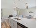 Stylish kitchen island with stainless steel sink and appliances overlooks living area with lots of light at 4343 Killdeer Ter, North Port, FL 34288