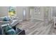 Open-concept living room showcasing stylish flooring, natural light, and seamless transition to other living spaces at 4343 Killdeer Ter, North Port, FL 34288