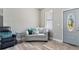 Cozy living room featuring a stylish sofa and a decorative front door at 4343 Killdeer Ter, North Port, FL 34288