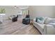 Open-concept living space featuring modern furniture and wood-look floors at 4343 Killdeer Ter, North Port, FL 34288