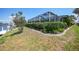 Landscaped backyard with a screened lanai and direct access to the canal at 505 Via Cintia, Punta Gorda, FL 33950