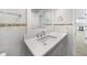 Bathroom with white vanity, decorative tile, and view into adjacent rooms at 505 Via Cintia, Punta Gorda, FL 33950