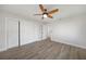 Bedroom featuring a ceiling fan, light wood floors, and a closet with sliding doors at 505 Via Cintia, Punta Gorda, FL 33950
