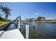 View of the canal and private dock, with a boat lift for easy access to waterway at 505 Via Cintia, Punta Gorda, FL 33950