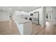 Bright kitchen boasts stainless appliances, white cabinets, subway tile backsplash and large quartz breakfast bar at 505 Via Cintia, Punta Gorda, FL 33950