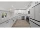 Modern kitchen featuring stainless steel appliances, white cabinets, a subway tile backsplash, and a breakfast bar at 505 Via Cintia, Punta Gorda, FL 33950