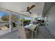 Screened-in patio with a dining table, ceiling fan, and waterfront views at 505 Via Cintia, Punta Gorda, FL 33950