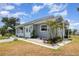 Inviting single-story home with a well-maintained lawn and decorative landscaping at 5121 Chaves Cir, Port Charlotte, FL 33948