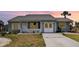 Charming single-story home featuring a well-manicured lawn and a cozy front porch with white picket fence at 5121 Chaves Cir, Port Charlotte, FL 33948