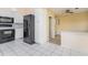 Bright eat-in kitchen with black appliances, white cabinetry, and tile floor at 5121 Chaves Cir, Port Charlotte, FL 33948