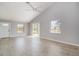 Bright living room features vaulted ceilings, tile floors, large windows, and a sliding glass door at 5121 Chaves Cir, Port Charlotte, FL 33948