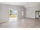 Bright living room features vaulted ceilings, tile floors, large windows, and a sliding glass door at 5121 Chaves Cir, Port Charlotte, FL 33948
