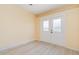 Light and airy room with white ceramic tile floors, a neutral paint, and an exterior door at 5121 Chaves Cir, Port Charlotte, FL 33948